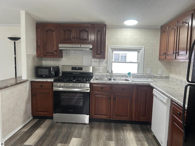 kitchen with dark wood-type flooring, sink, black appliances, and a textured ceiling