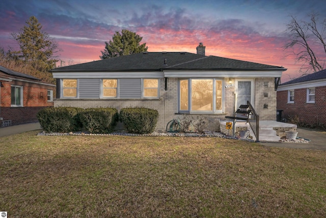 view of front facade featuring a yard and a patio