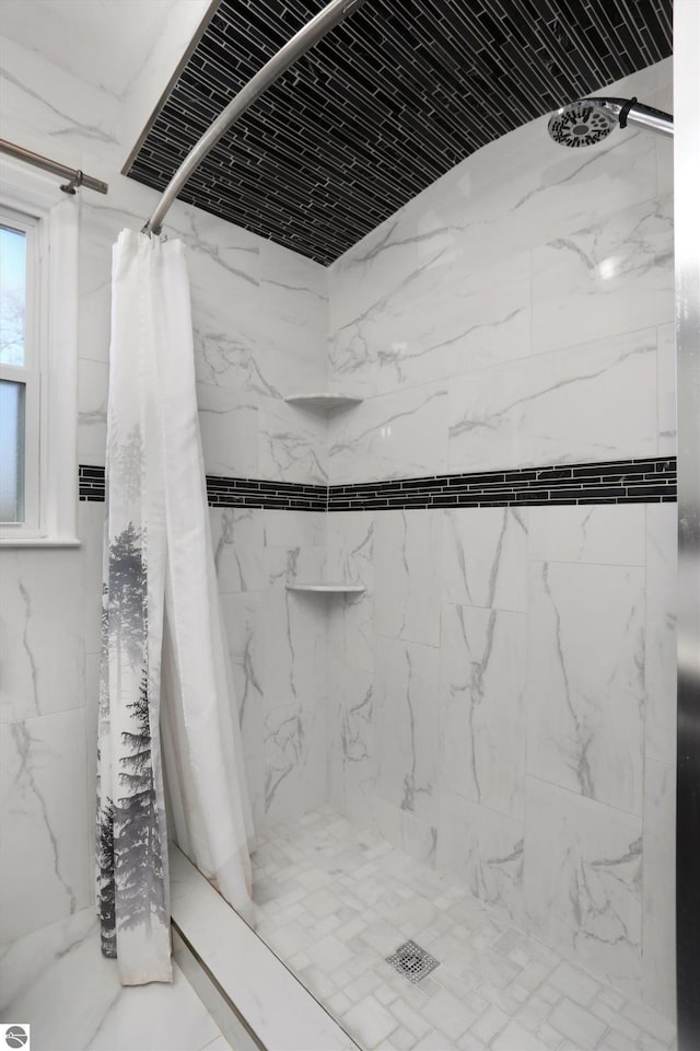 bathroom with brick ceiling and a shower with shower curtain