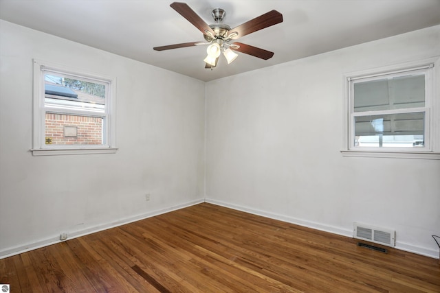 empty room with ceiling fan and hardwood / wood-style floors