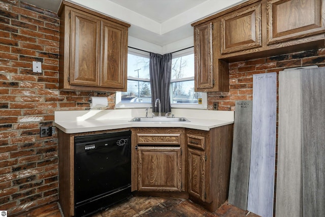 kitchen featuring dishwasher, brick wall, and sink