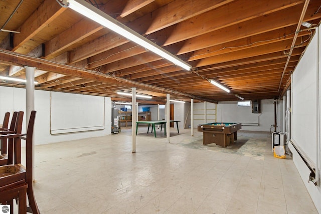 basement featuring electric panel, gas water heater, and pool table