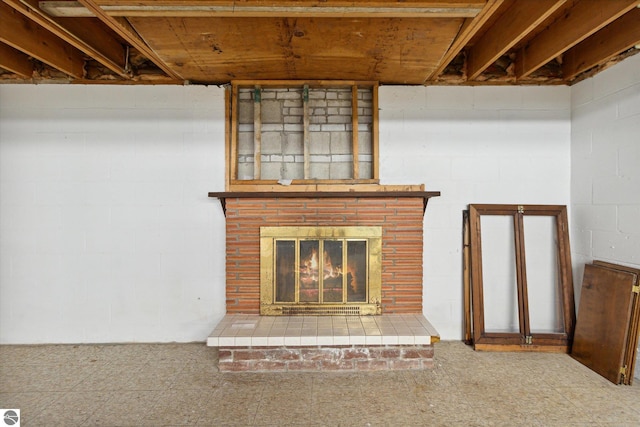 unfurnished living room featuring a brick fireplace