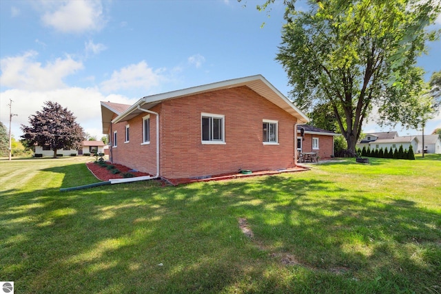 rear view of property featuring a yard