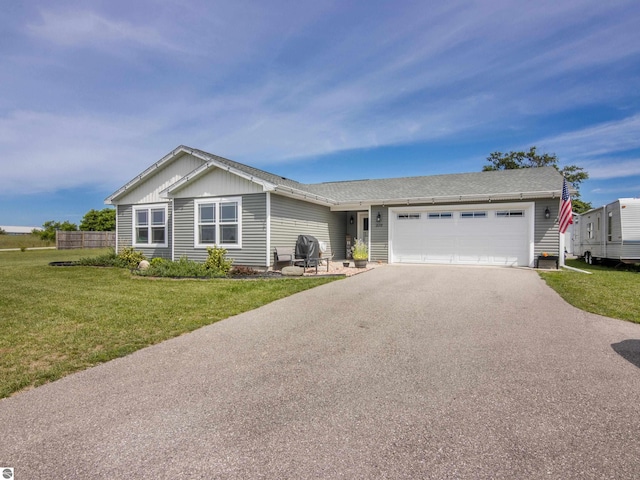 ranch-style home featuring a front yard and a garage