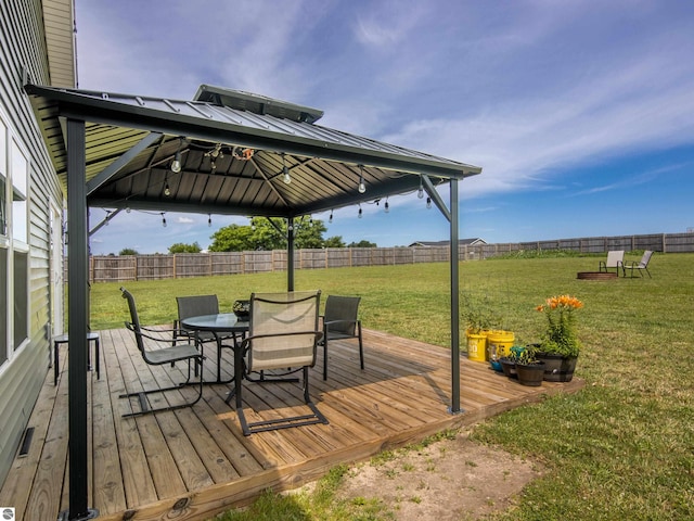 wooden terrace with a gazebo and a lawn