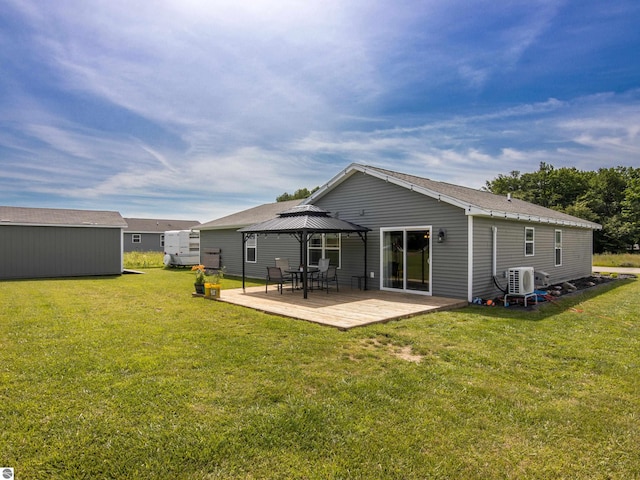 back of property featuring a gazebo, a yard, and ac unit