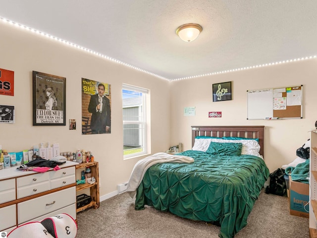 carpeted bedroom featuring a textured ceiling