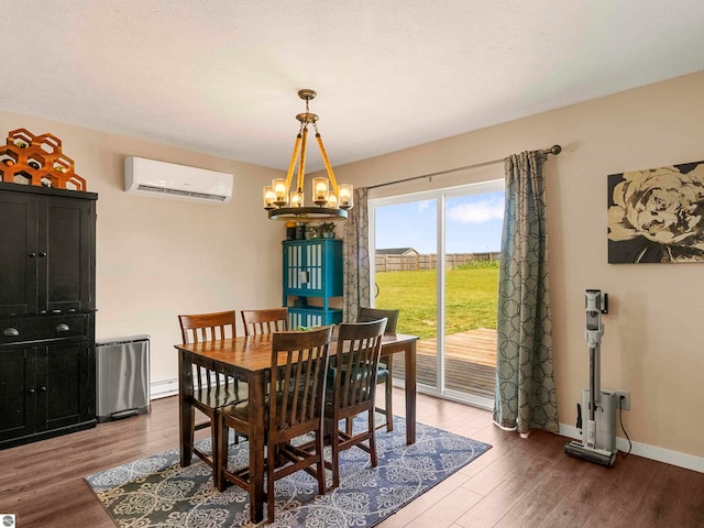 dining area with a wall unit AC, wood-type flooring, and an inviting chandelier