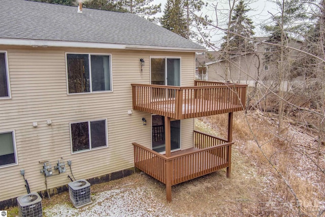 back of property with a balcony and central air condition unit