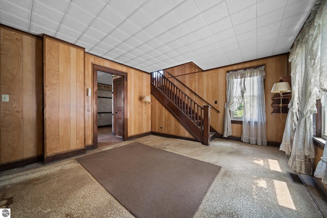 entryway with wood walls