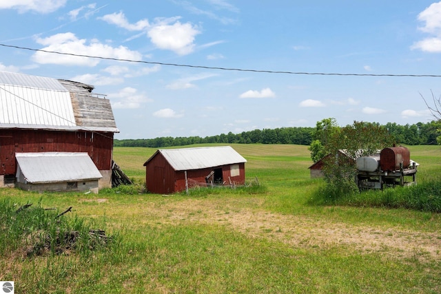 view of yard featuring an outbuilding and a rural view