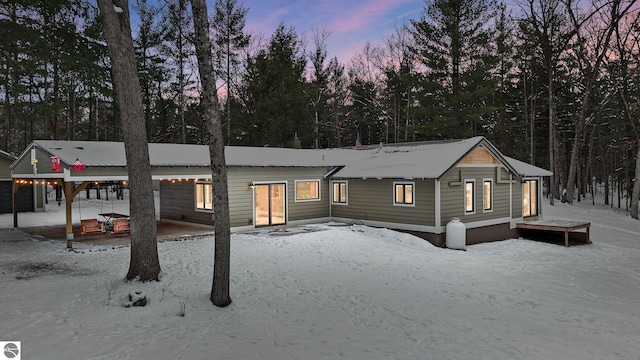 view of snow covered rear of property