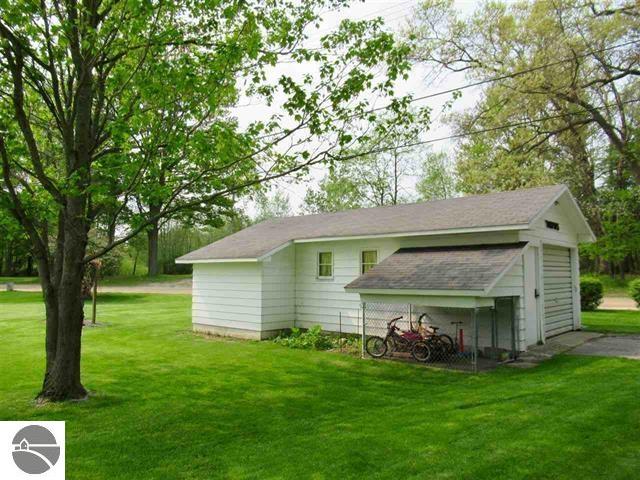 view of outbuilding with a yard and a garage