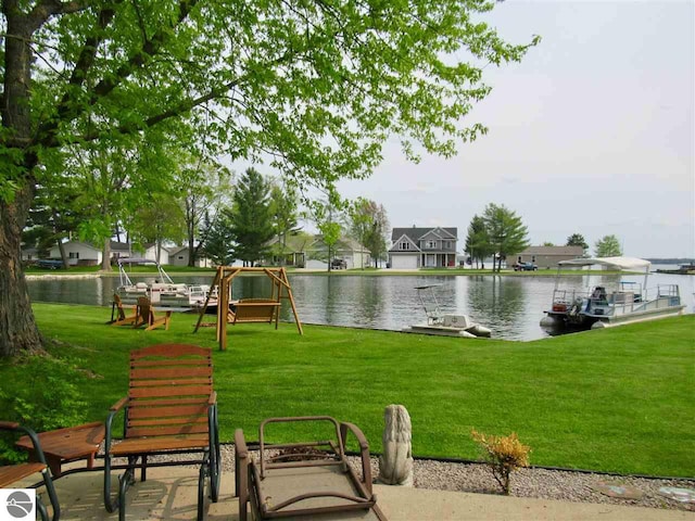 exterior space with a lawn and a water view