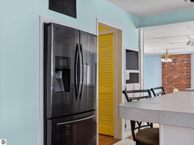 kitchen featuring stainless steel refrigerator with ice dispenser