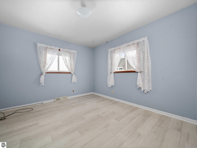 spare room featuring light hardwood / wood-style floors