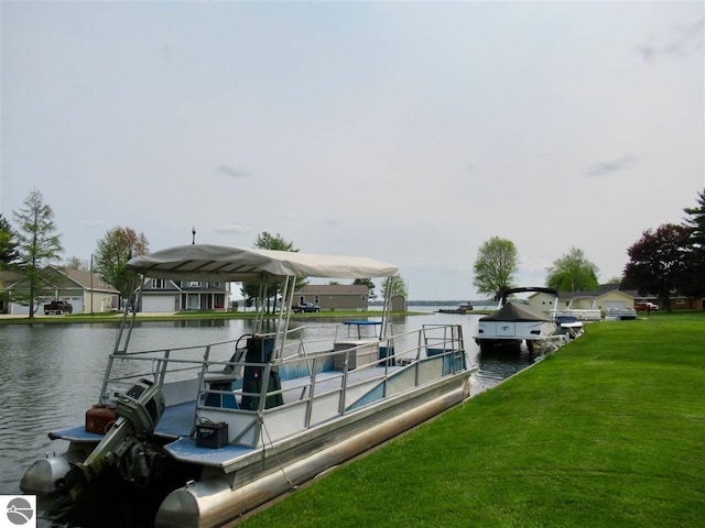 dock area with a water view and a lawn