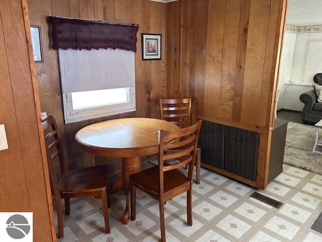 dining room with wood walls