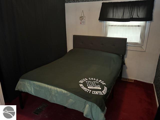 bedroom featuring dark colored carpet