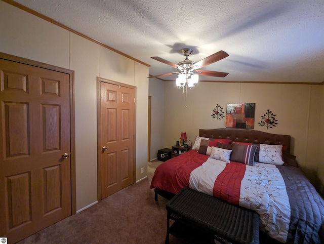 bedroom featuring carpet, a textured ceiling, ceiling fan, and ornamental molding