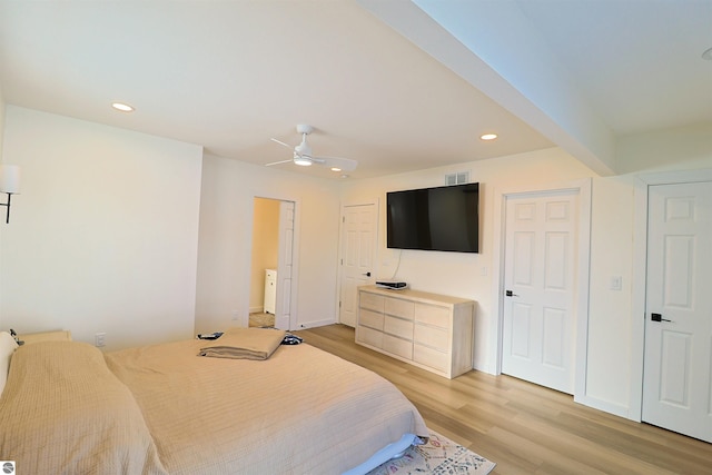 bedroom featuring beamed ceiling, light wood-type flooring, and ceiling fan