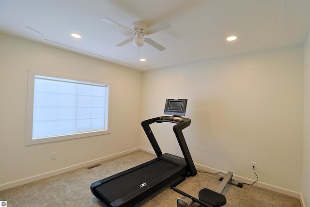 exercise room featuring light colored carpet and ceiling fan