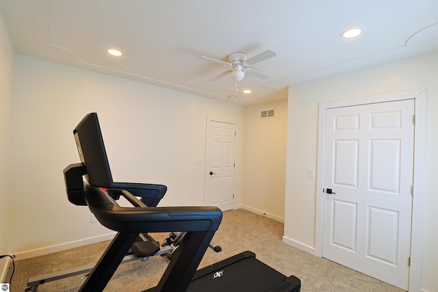 workout room with light carpet and ceiling fan