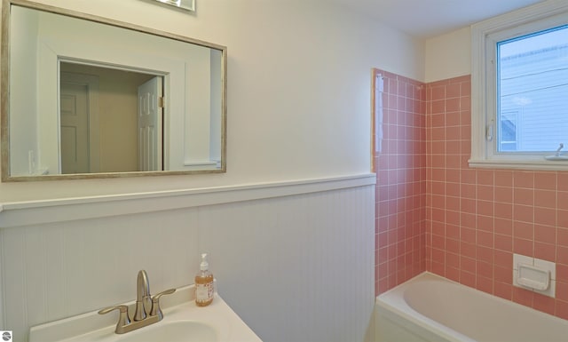 bathroom with shower / tub combination and sink