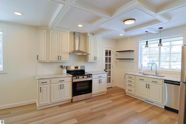 kitchen featuring sink, wall chimney exhaust hood, hanging light fixtures, stainless steel appliances, and light wood-type flooring