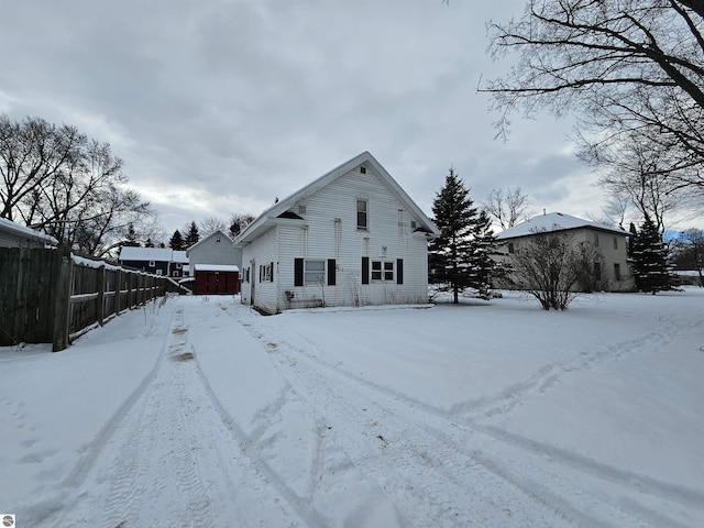 view of snow covered back of property