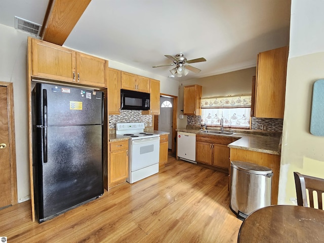 kitchen featuring decorative backsplash, light wood-type flooring, ceiling fan, sink, and black appliances