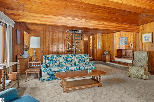 carpeted living room with wood walls, wood ceiling, stairway, and beam ceiling