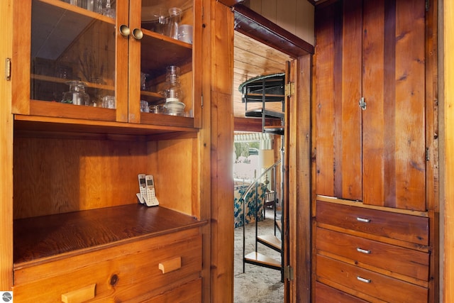 interior details with carpet floors and wooden walls