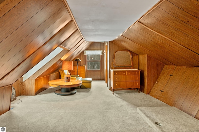 additional living space featuring lofted ceiling, carpet, and wooden walls