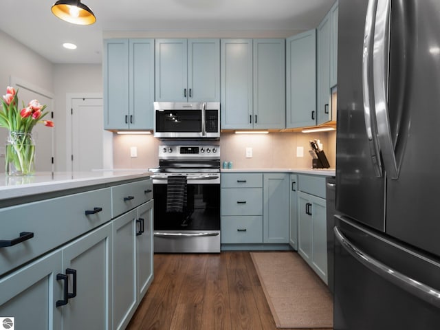 kitchen featuring tasteful backsplash, dark hardwood / wood-style flooring, and stainless steel appliances