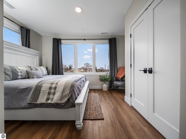 bedroom with dark hardwood / wood-style flooring