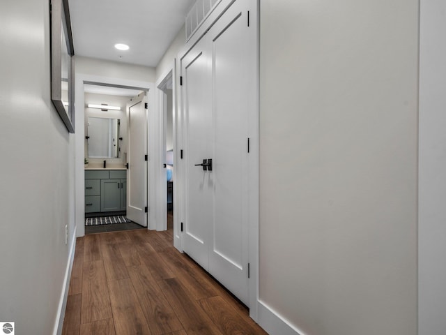 hallway with dark hardwood / wood-style floors