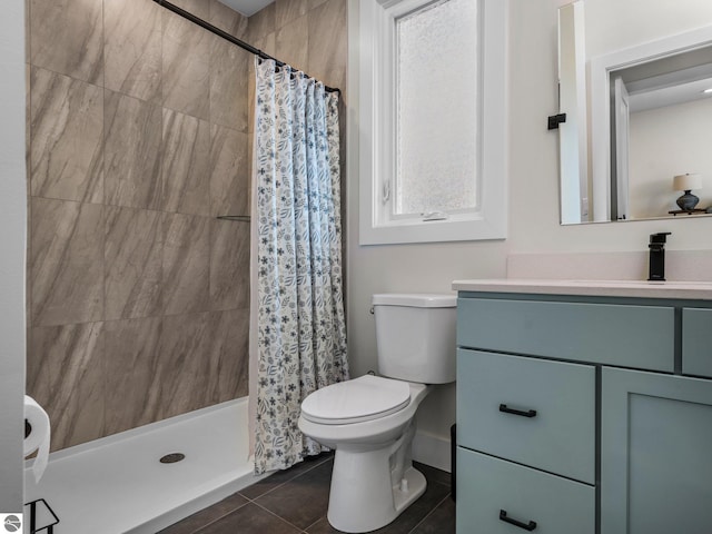 bathroom featuring tile patterned floors, vanity, toilet, and walk in shower