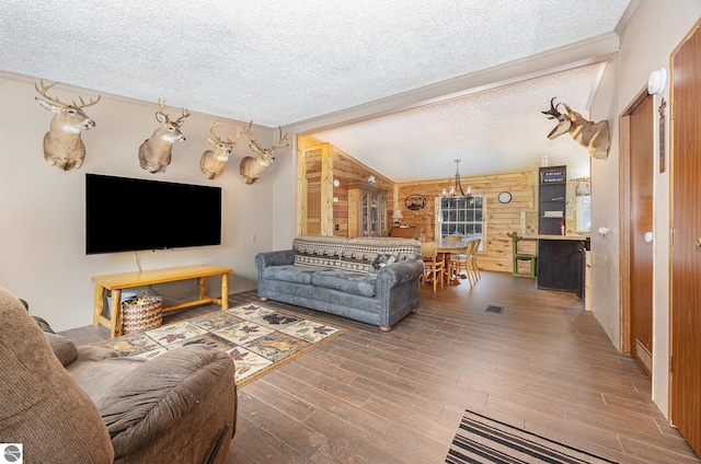 living room with wood-type flooring, vaulted ceiling, a textured ceiling, and wood walls