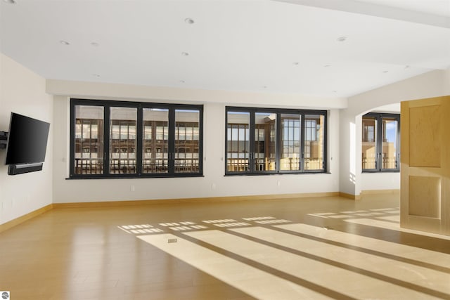 unfurnished living room featuring light wood-type flooring