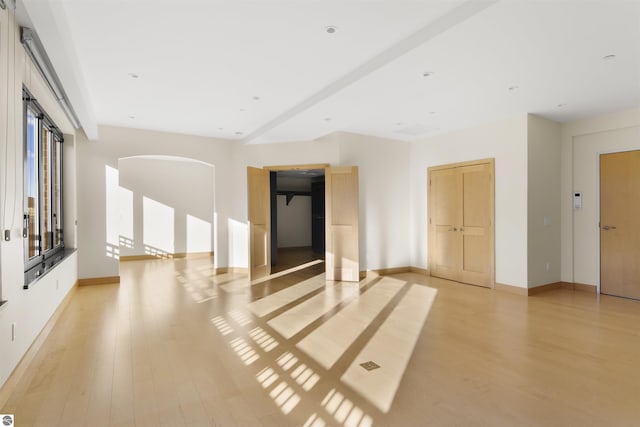 empty room with light hardwood / wood-style flooring