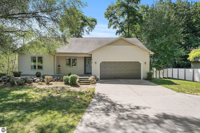 view of front of property featuring a front yard and a garage