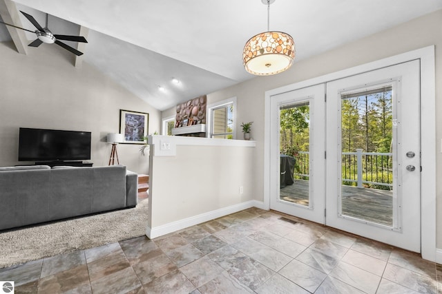 entryway featuring ceiling fan and lofted ceiling