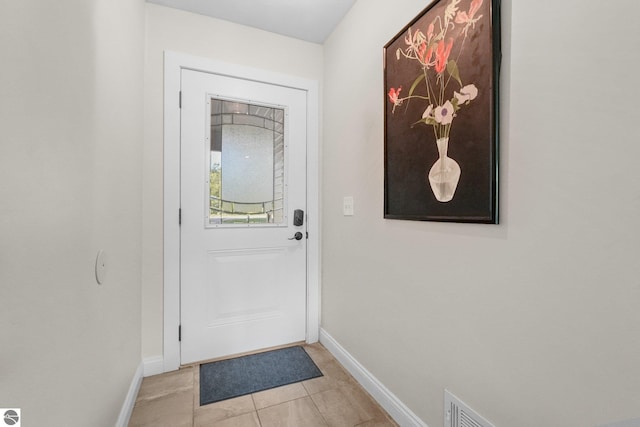 doorway featuring light tile patterned flooring