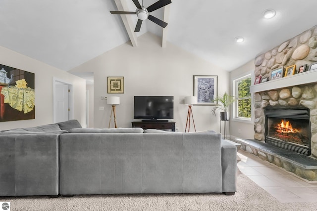 living room featuring vaulted ceiling with beams, ceiling fan, light tile patterned flooring, and a fireplace