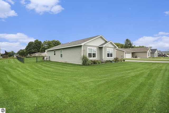 view of side of home with a lawn and a garage