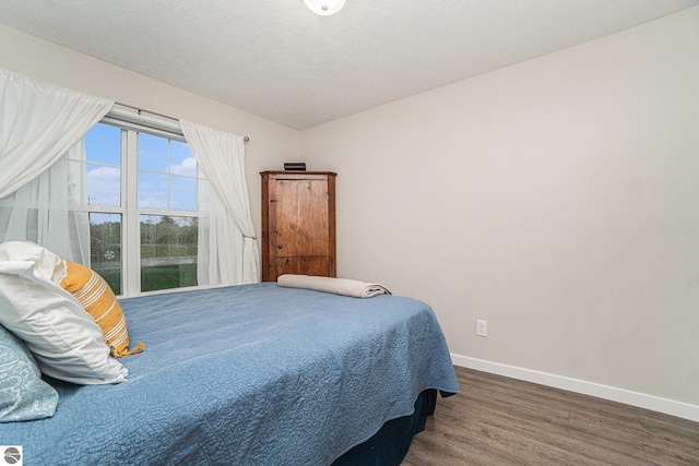 bedroom featuring dark hardwood / wood-style flooring