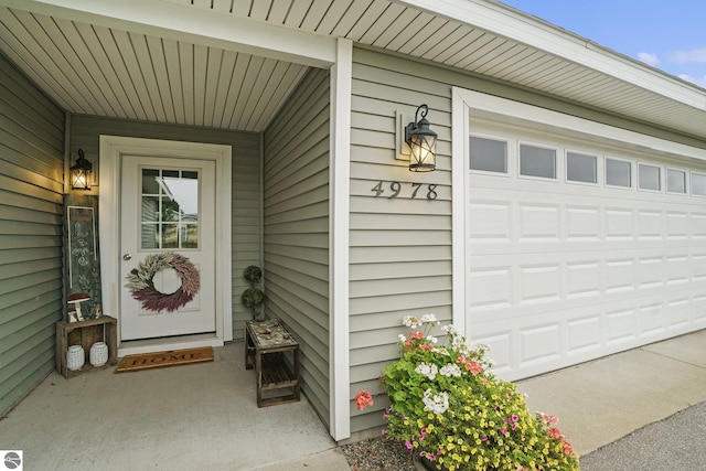 view of exterior entry with a garage