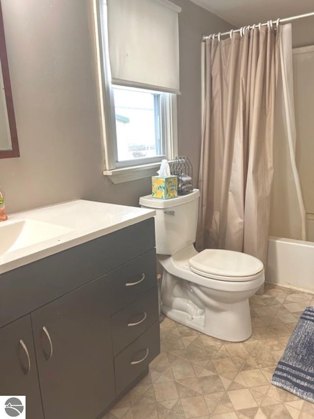 full bathroom featuring vanity, toilet, and shower / tub combo